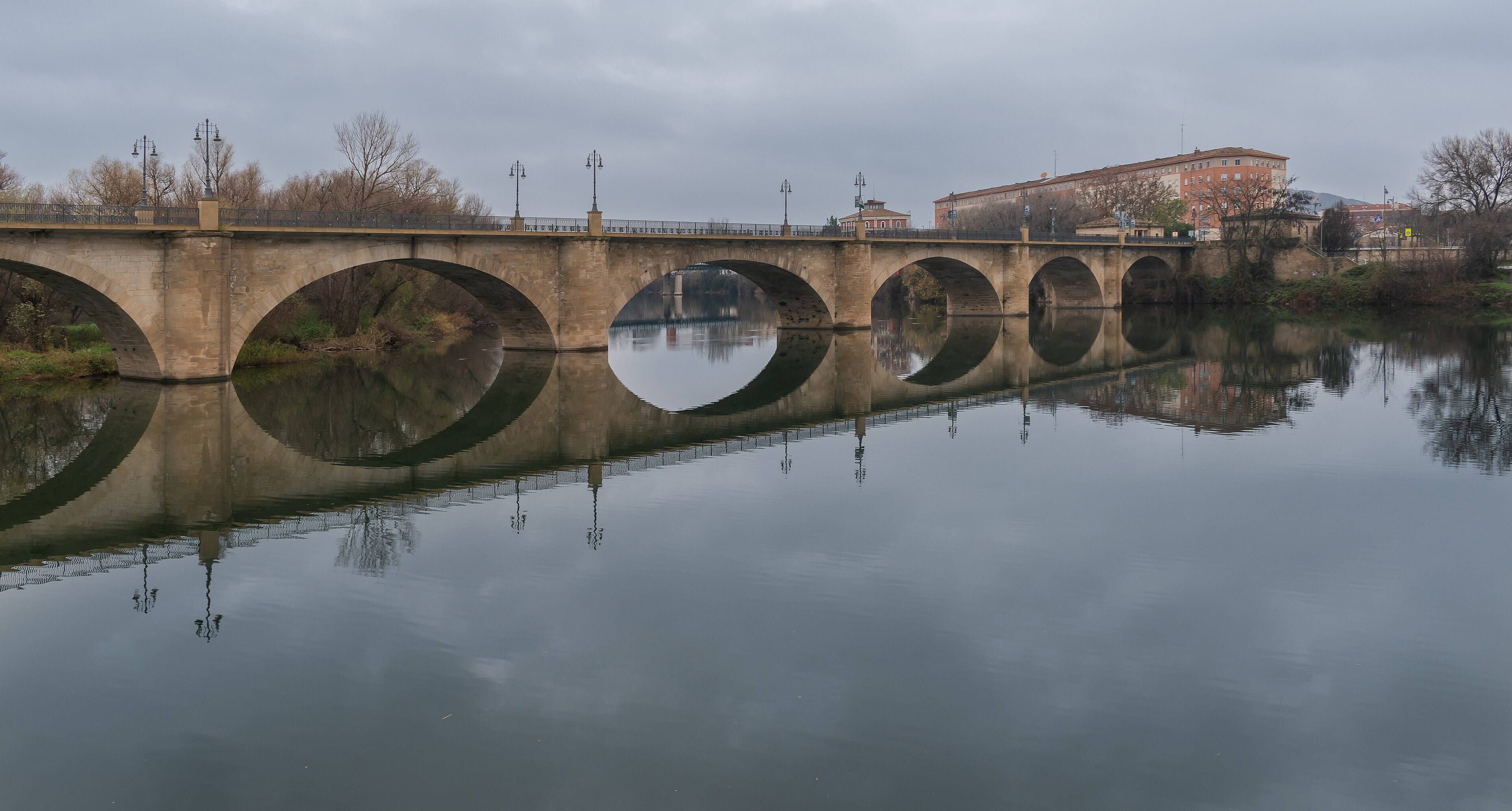 El Puente de Piedra sobre el río Ebro en Logroño, reflejado en el agua